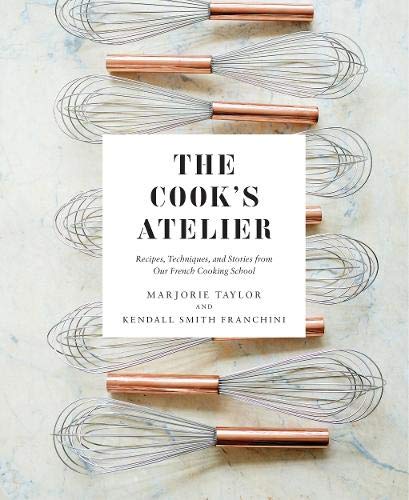 Cookbook cover with title and surrounding copper whisks on marble.