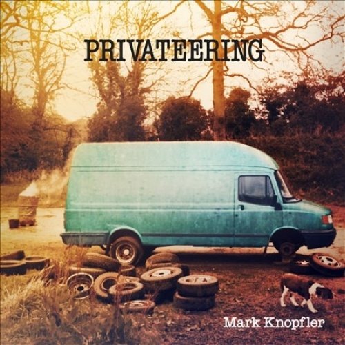 Album cover showing a teal van surrounded by tires with a dog nearby.