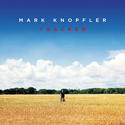 A man stands in a golden field under a blue sky on this album cover.