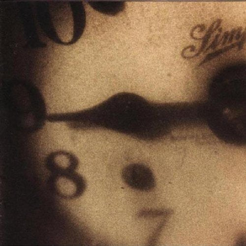 Close-up, blurry image of a clock faceB face with numbers 7, 8, 9, and 10.