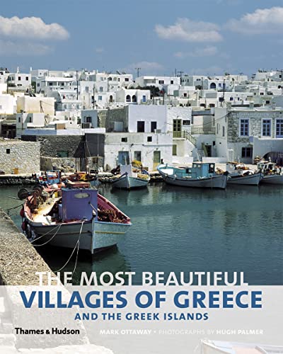 Whitewashed Greek village and colorful boats in a harbor.