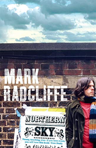 Book cover with author's name and a man standing by posters.