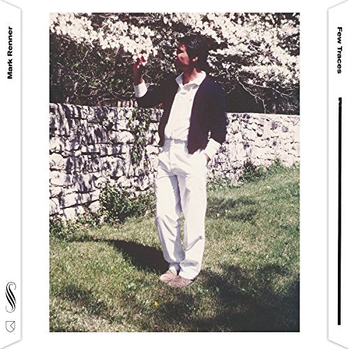 CD cover: Man in white suit stands under blossoming tree.