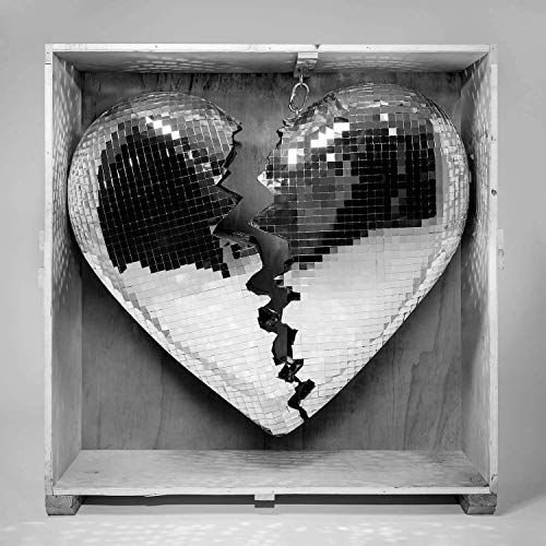 Broken mirrored heart shape inside a wooden crate, grayscale image.