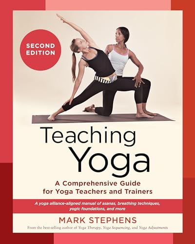A thick, second edition yoga manual with a serene cover and detailed interior pages.