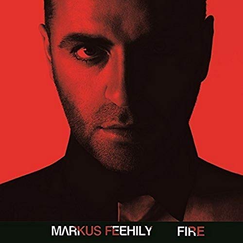 Markus Feehily album cover, close-up of a man’s face on a red background.