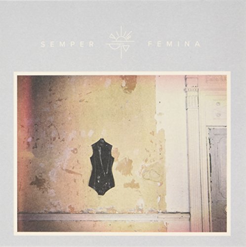 CD cover: distressed wall with a black corset and text above.