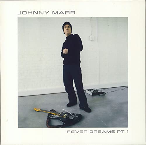 Johnny Marr album cover: man with guitar case in a white room.