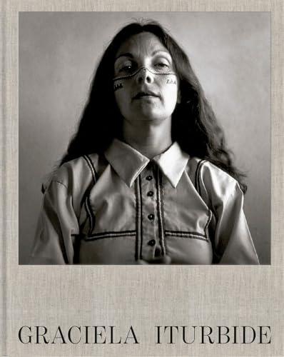 Black and white portrait of Graciela Iturbide with painted facial markings.