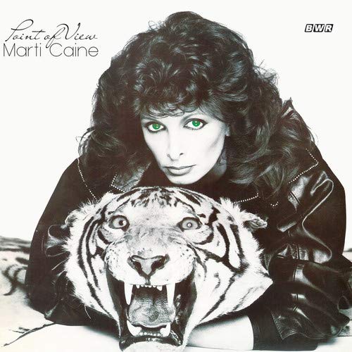 "Album cover featuring a woman with a tiger's head, black and white with green eyes."