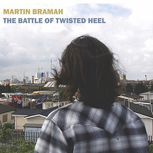 CD cover: man viewed from behind, city skyline in background.