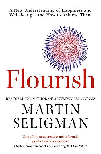 Book cover for Flourish by Martin Seligman featuring a red and blue firework graphic.