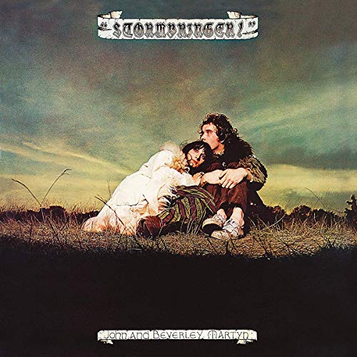 Album cover: couple embracing in a field under a stormy sky.