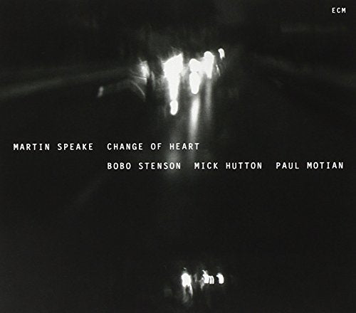 "Album cover with dark, blurry road scene and white text listing artist and musicians."