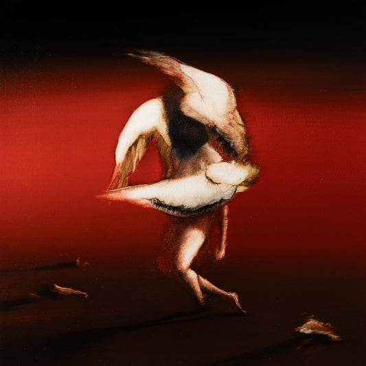 A blurry, abstract figure with wing-like shapes against a dark red and black background.
