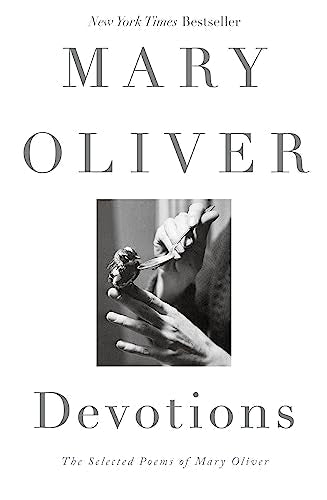 Book cover: "Devotions" by Mary Oliver, with a hand holding a flower.