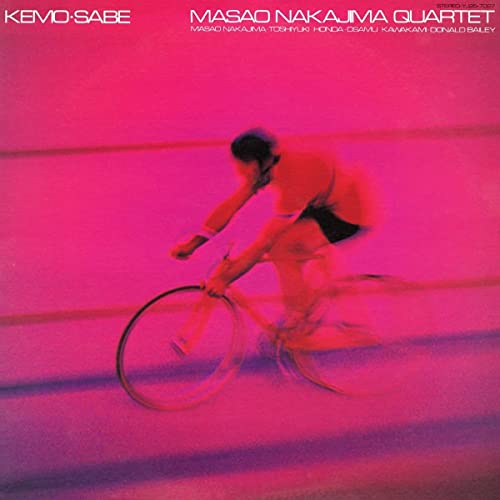 Red vinyl album cover featuring a blurred cyclist in motion.