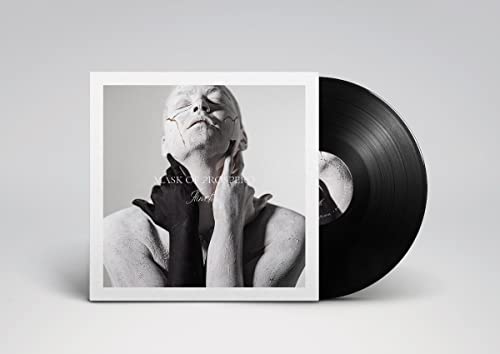 Vinyl record with album cover featuring a person with cracked face art.