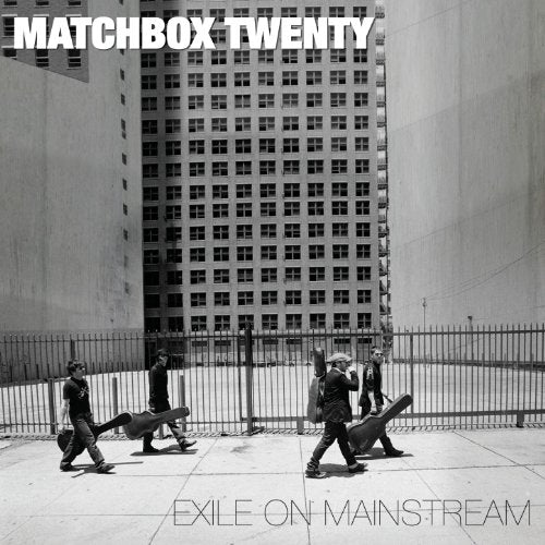 Black and white photo of Matchbox Twenty members walking with guitar cases before buildings.