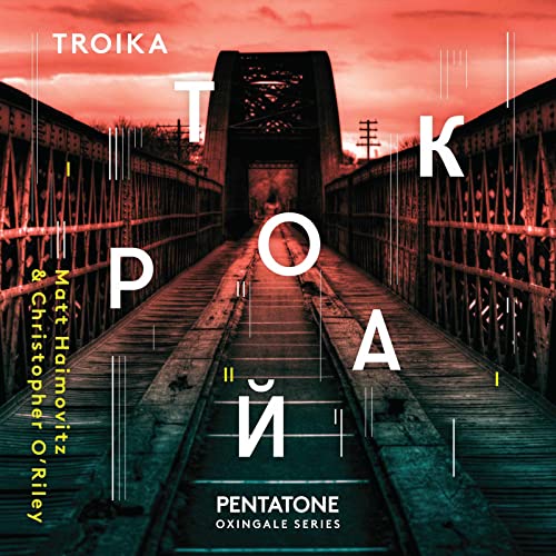 CD cover featuring a red-lit metal bridge with overlaid white text reading Troika.