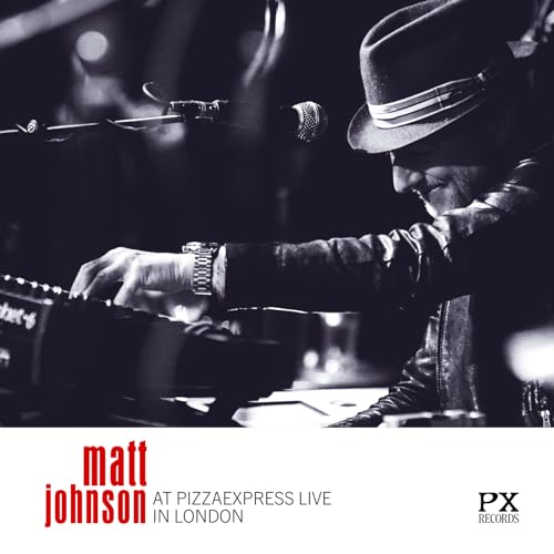 Black and white photo of Matt Johnson playing a keyboard while wearing a hat.
