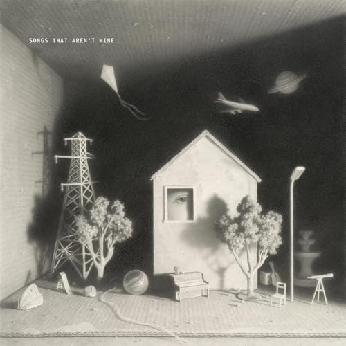 Black and white album cover with miniature house, kite, and airplane.