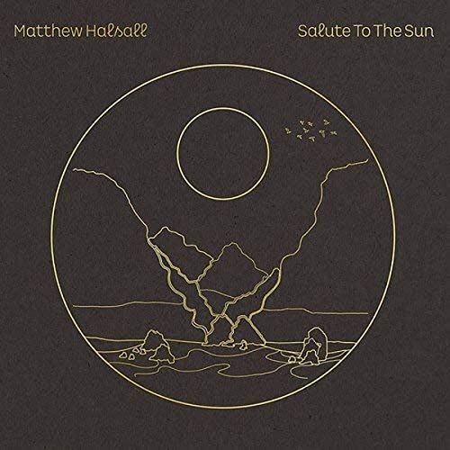Gold line art of a sun, mountains, and birds inside a circle on dark.