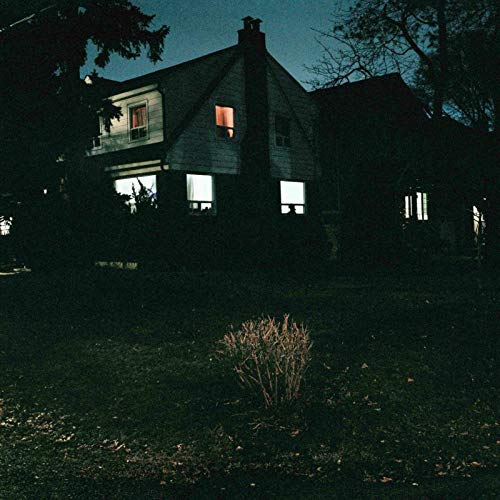 "Album cover featuring a dark house at night with lit windows."