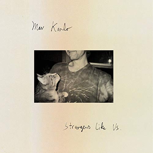 "Album cover with black-and-white photo of man holding cat, beige background, handwritten text."