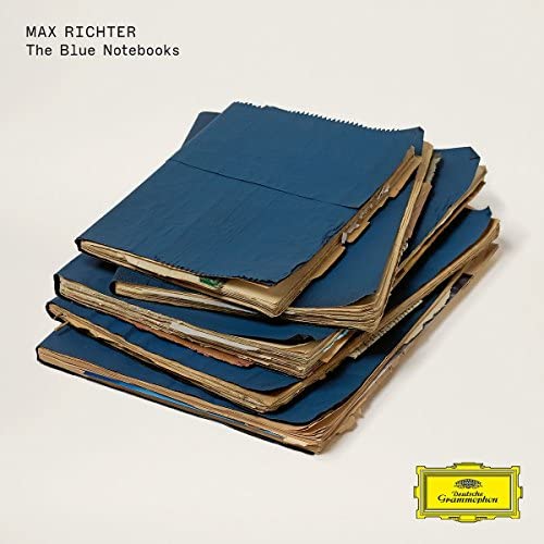Stack of worn, blue notebooks with a Deutsche Grammophon logo.