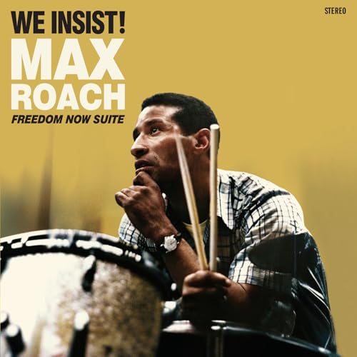 Max Roach holding drumsticks with a drum set in the foreground against yellow background.