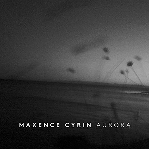 CD cover for Maxence Cyrin’s “Aurora” featuring a blurred, dark landscape.