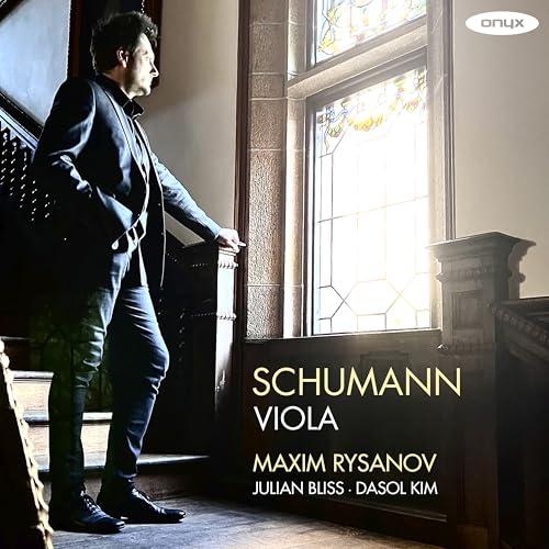 CD cover featuring a man in a suit standing by a window.