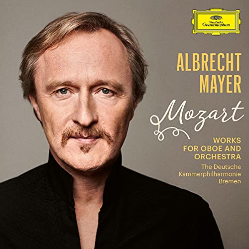 CD cover featuring a man with a mustache and black shirt.