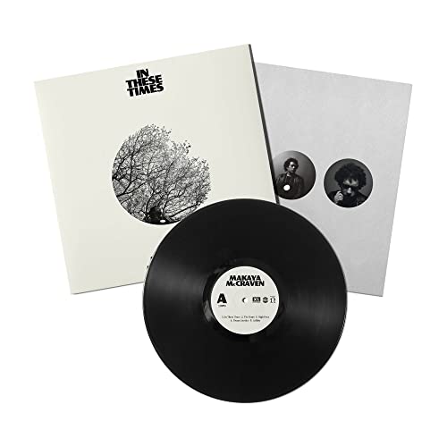 Vinyl record with white album cover featuring a silhouetted tree.