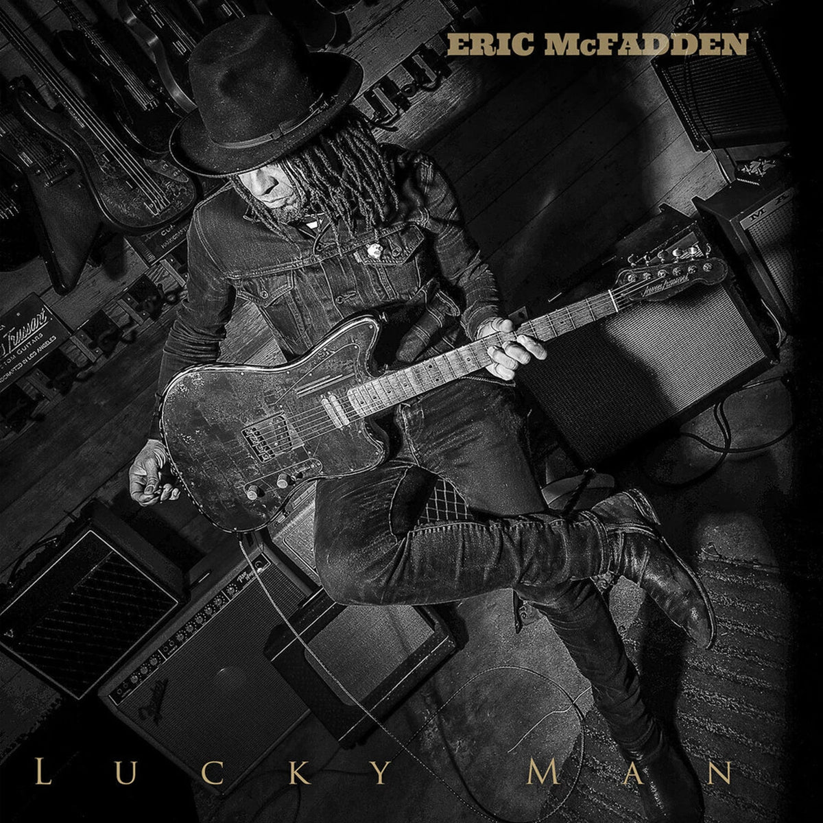 Black and white album cover featuring Eric McFadden with guitars.