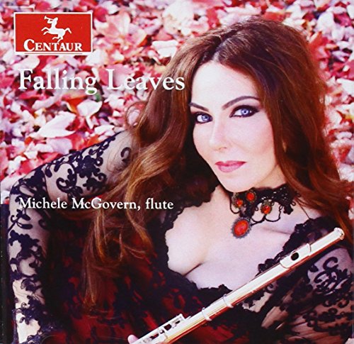 A woman in a red dress holds a flute, surrounded by fallen leaves.