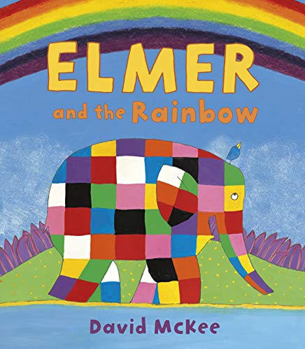 A colorful patchwork elephant stands on a grassy hill beneath a rainbow.