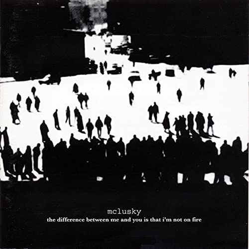 High-contrast black and white image of silhouettes of people walking across a snowy field.