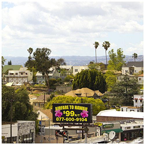 Billboard advertising $99 roundtrip airfare to Hawaii over a residential area.