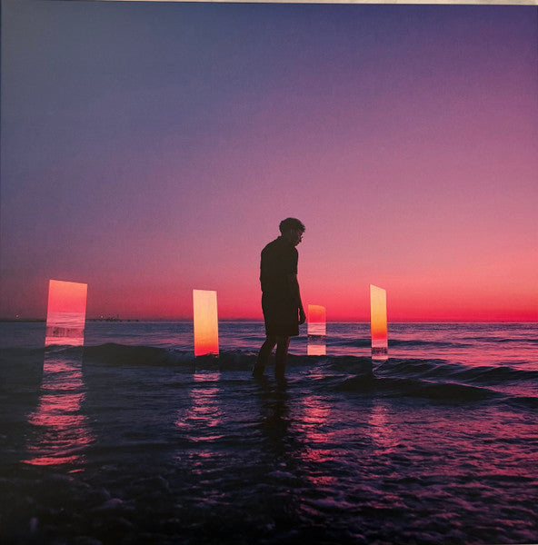 Vinyl record cover with a silhouetted figure by glowing, rectangular lights.
