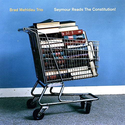 Album cover: shopping cart overflowing with stacked books on blue background.