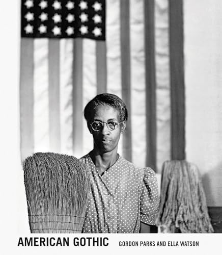 Black and white portrait of a woman with brooms, American flag backdrop.