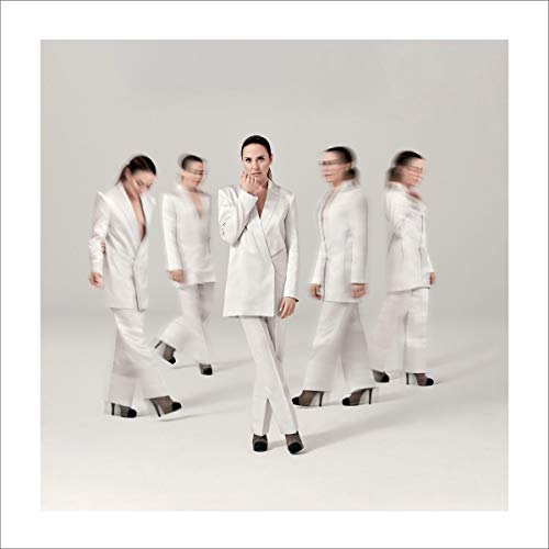 Melanie C in white suit, multiple exposures, against a plain gray background.