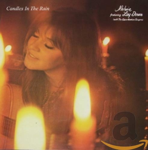 CD cover: Melanie portrait with lit candles, dark background.