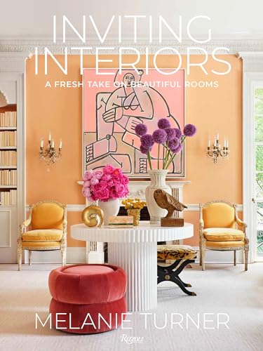 Book cover featuring a warmly lit room with art and floral arrangements.