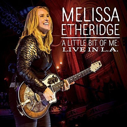 Melissa Etheridge playing a resonator guitar on stage with album title text overlaid.
