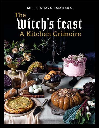 Book cover featuring a table laden with food, flowers, and a candelabra on black.