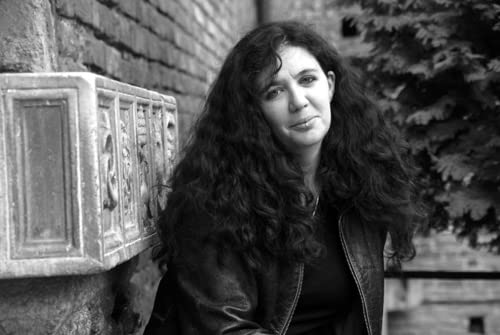Black and white portrait of a woman with long, curly hair.