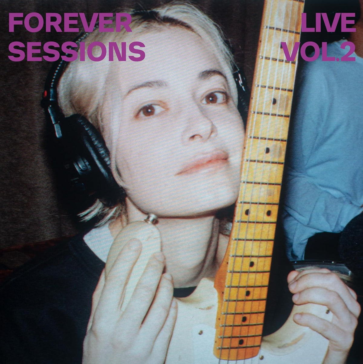 Woman with headphones holding a guitar, album cover for Men I Trust.
